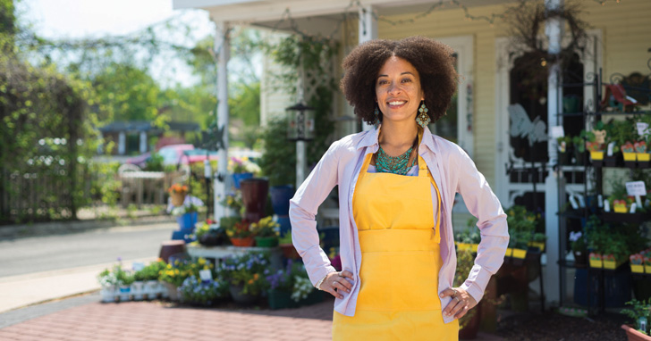 Woman standing proudly in front of her business